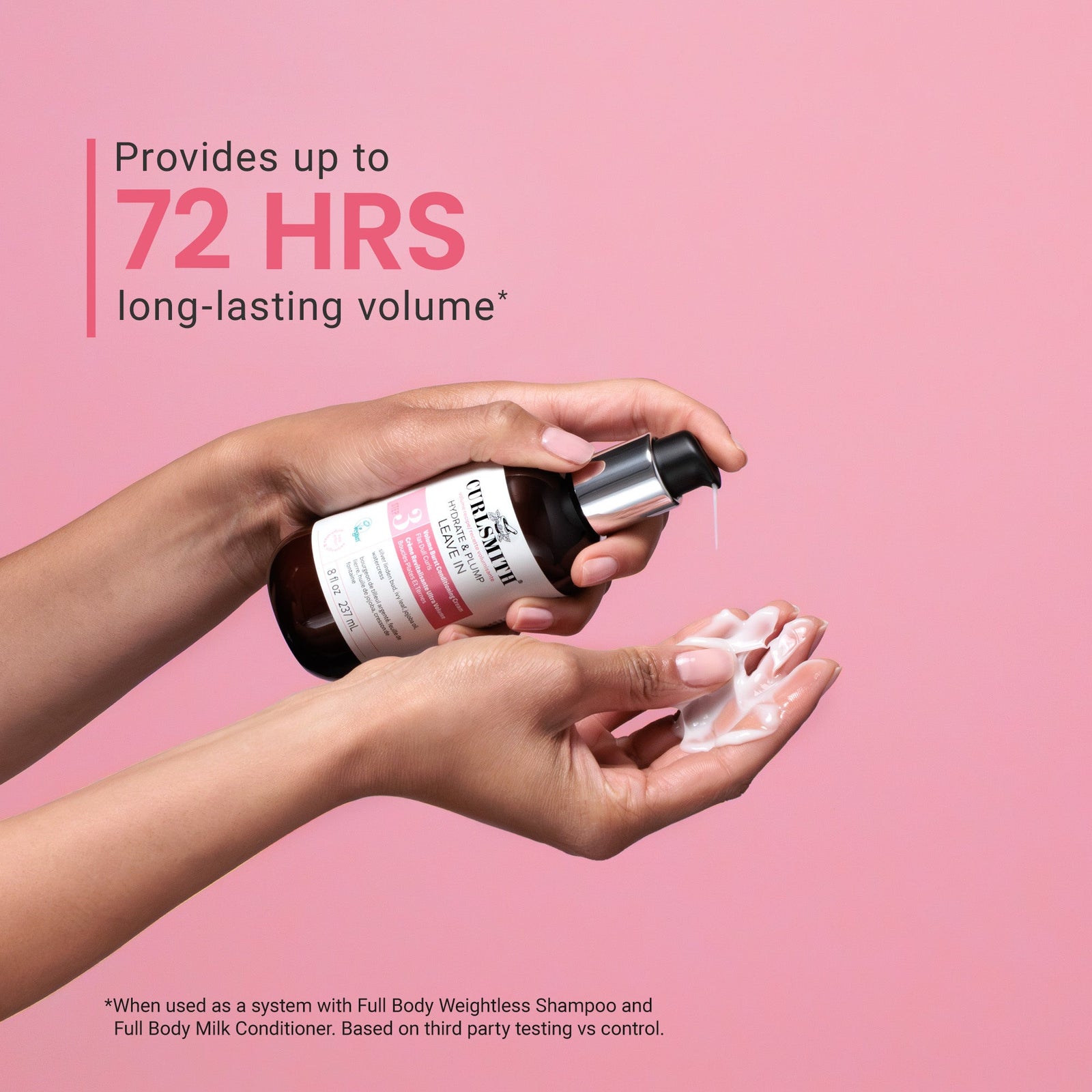Person holding a bottle of shampoo with soap suds on a pink background, promoting 72 hours of volume.