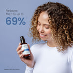Woman holding a bottle of hair product with text claiming to reduce frizz by up to 69% on a blue background.