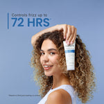 Woman with curly hair holding a bottle of hair product against a blue background, with text indicating control of frizz for up to 72 hours.