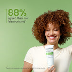 Woman holding a Curly Smith product with a green background and text about hair nourishment.