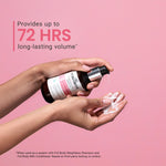 Person holding a bottle of shampoo with soap suds on a pink background, promoting 72 hours of volume.