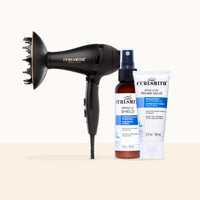 Curlsmith haircare set featuring a black diffuser attachment, a bottle of Miracle Shield hair protectant, and a tube of Long Curl Rehab Salve on a light beige background.
