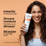 Woman holding a tube of Curlsmith hair care product with text about its benefits on an orange background