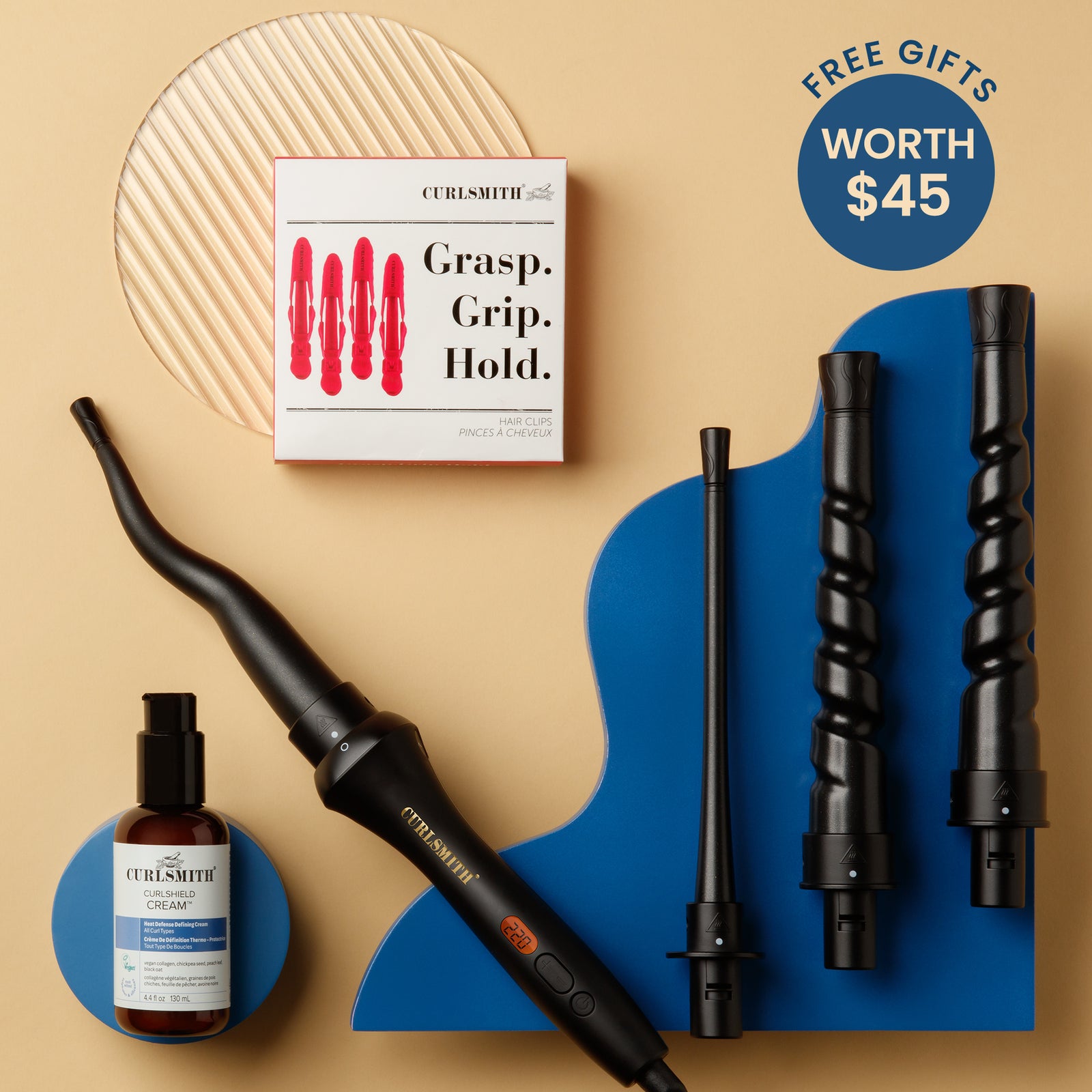 Hair styling tools and product set with 'Curlsmith' branding on a beige and blue background.